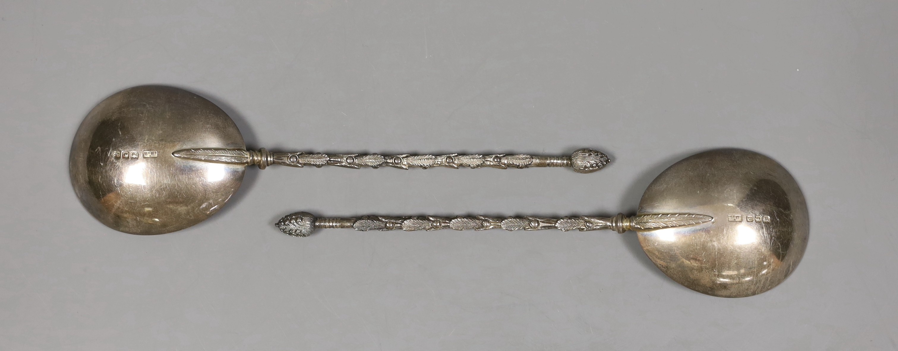 A pair of George V silver serving spoons, with ornate stems, Mappin & Webb, London, 1918/19, 19.6cm, 120 grams.